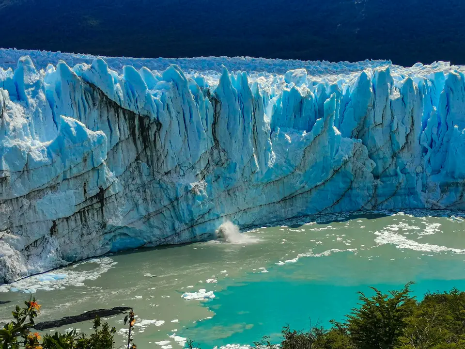 a large glacier with water below with Perito Moreno Glacier in the background — El Calafate