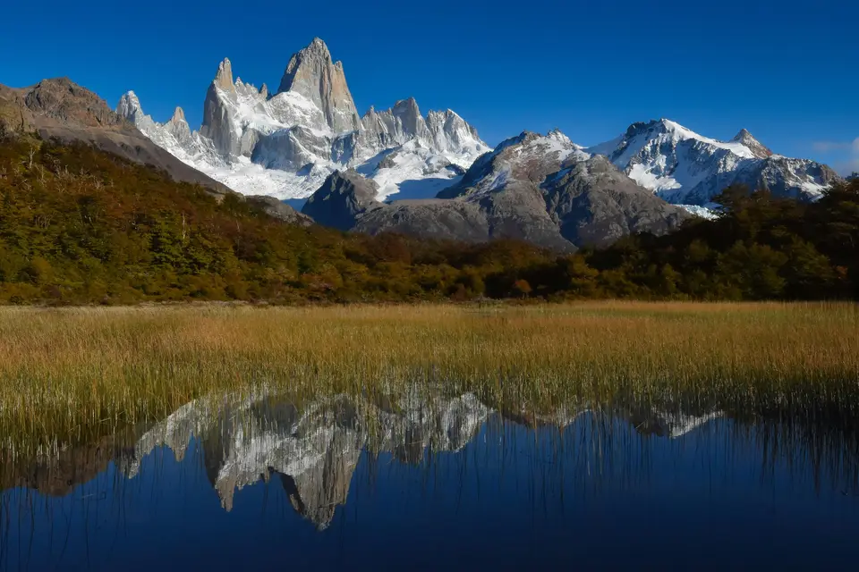 snow covered mountain near lake during daytime — El Chaltén