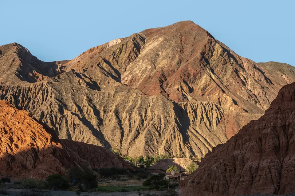 Sunlit desert mountains with colorful rock formations — Quebrada de Humahuaca