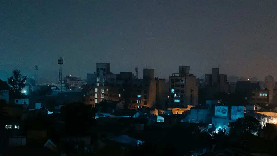 a city skyline at night with buildings lit up — Salta