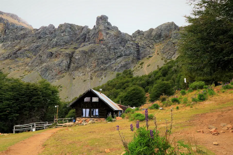 a house in front of a rocky mountain